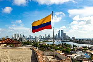 Colombian Flag infront of the skyline of Bogota