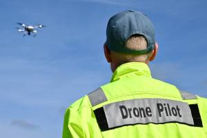 a drone pilot and a drone in the air