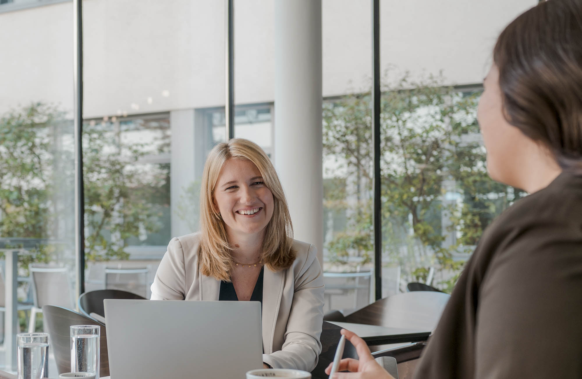 Frequentis Employer Branding header picture, showing two employee talking to each other