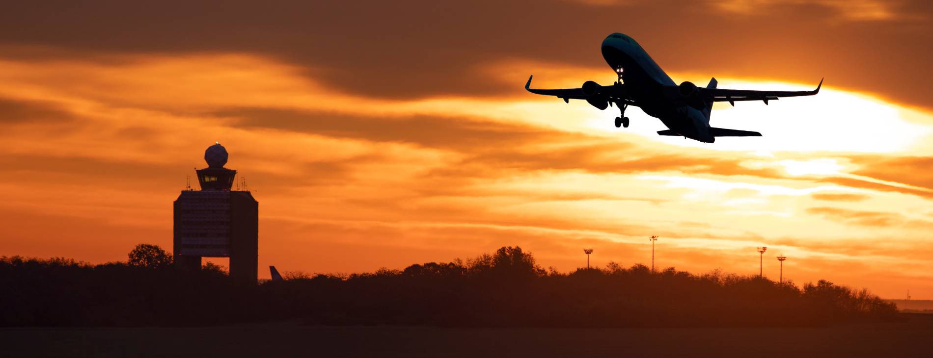 take-off of a plane with the tower of budapest during sunset