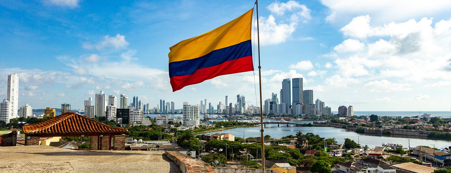 Colombian Flag infront of the skyline of Bogota